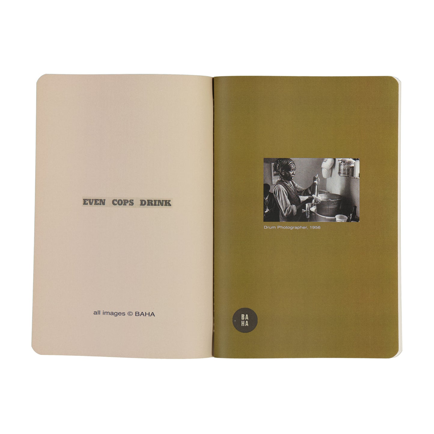 Open book with green cover and beige interior, featuring text and a black and white photo.
