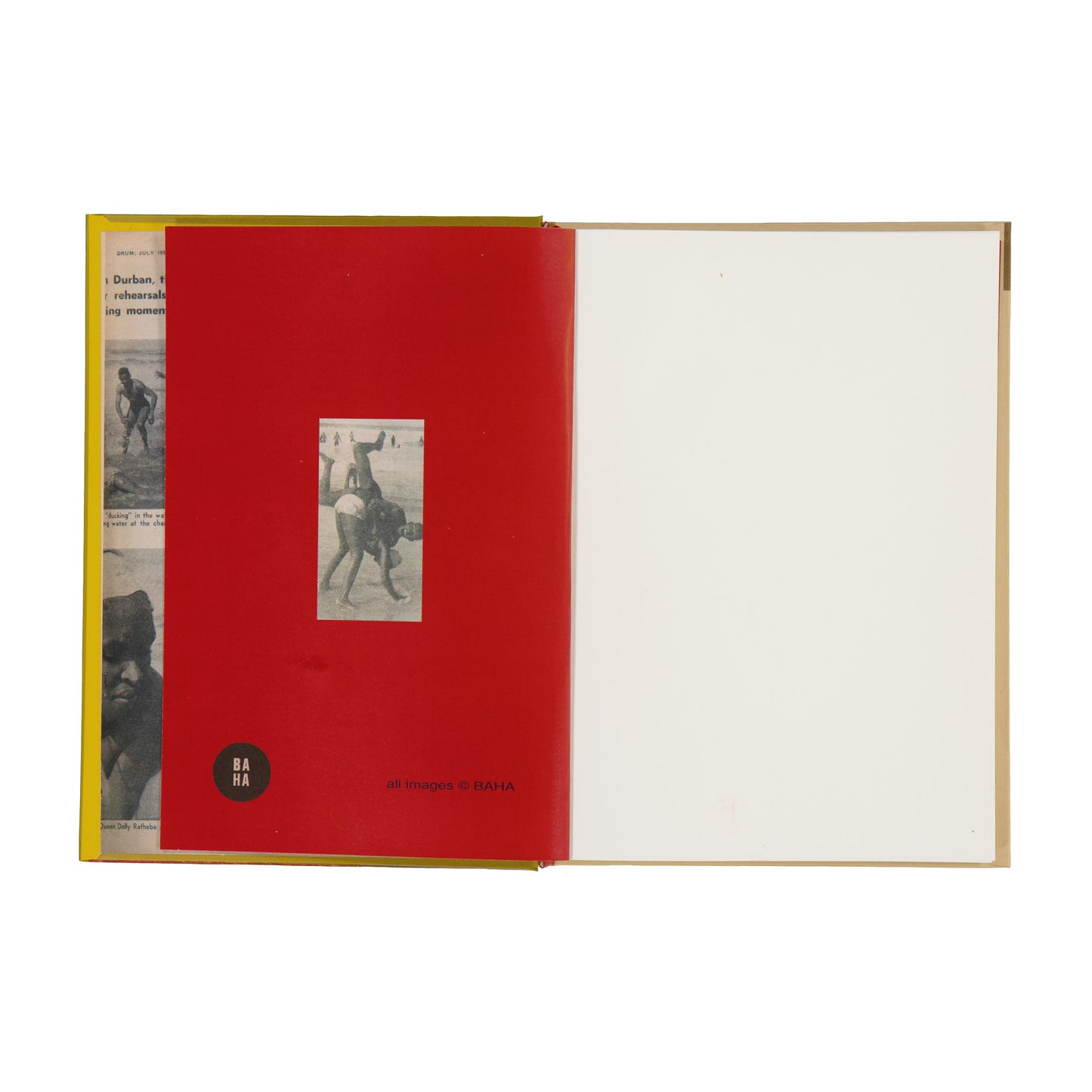 Open book with a red page featuring a small black and white photo, on a white background.