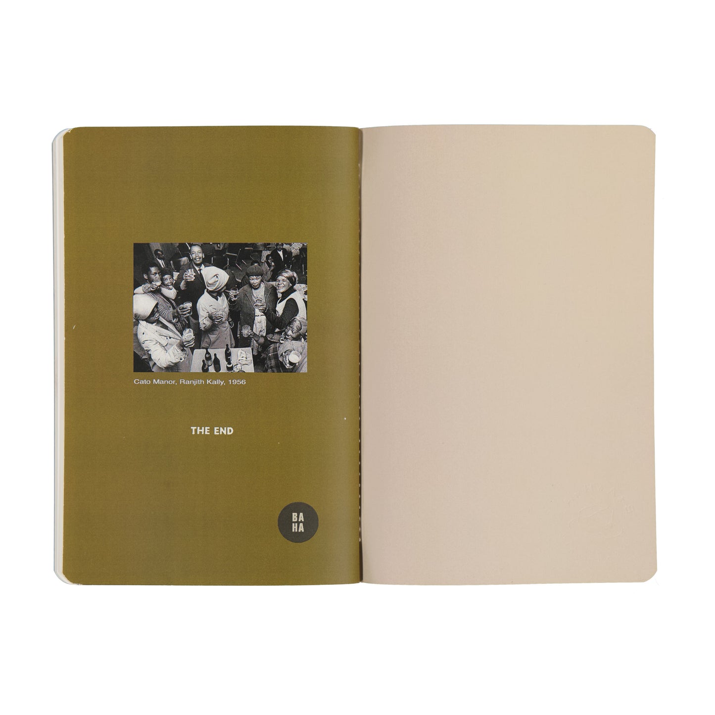 Open notebook with a photo and text on the left page and beige paper on the right page.