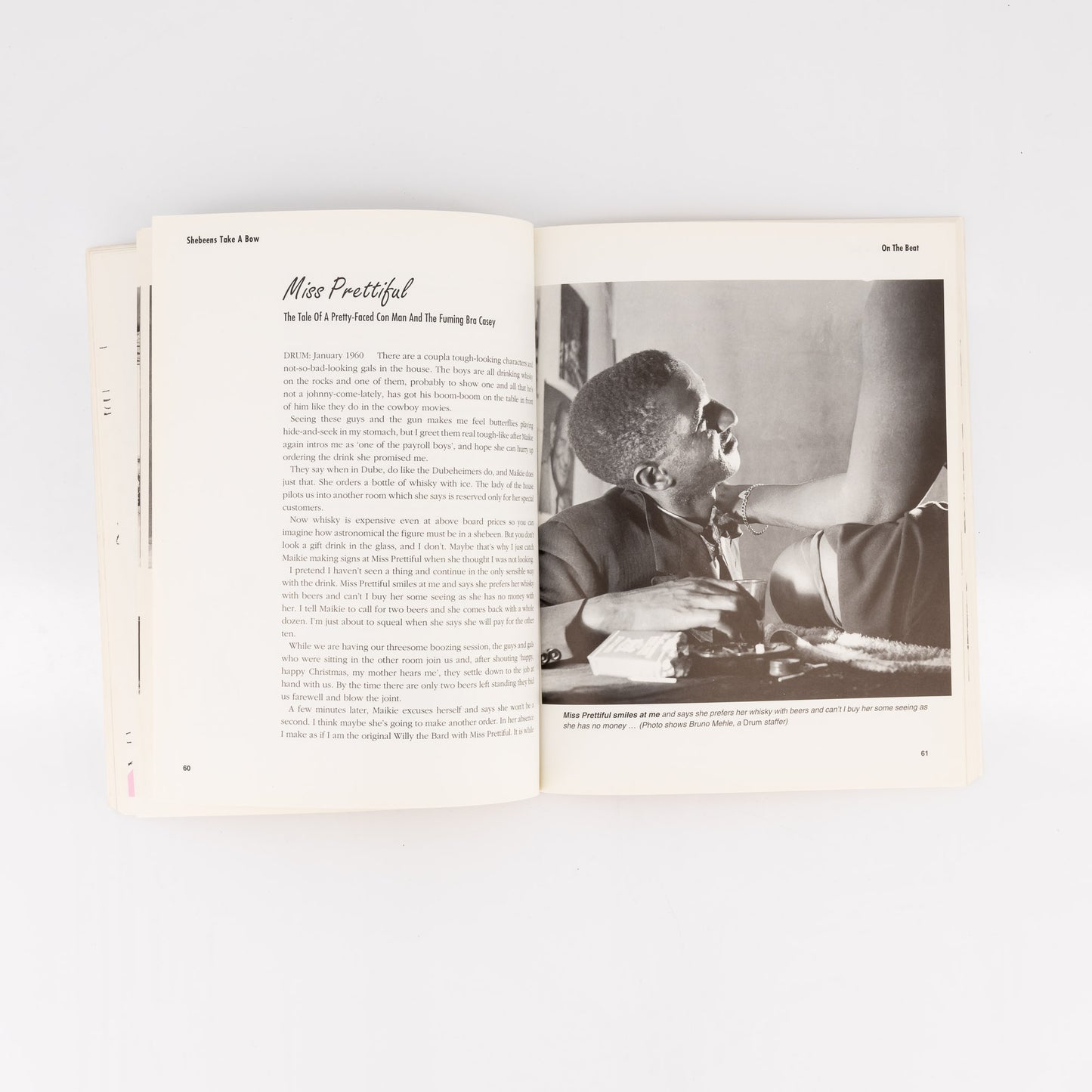 Open book with a black and white photo of a person sitting at a desk on the right page.
