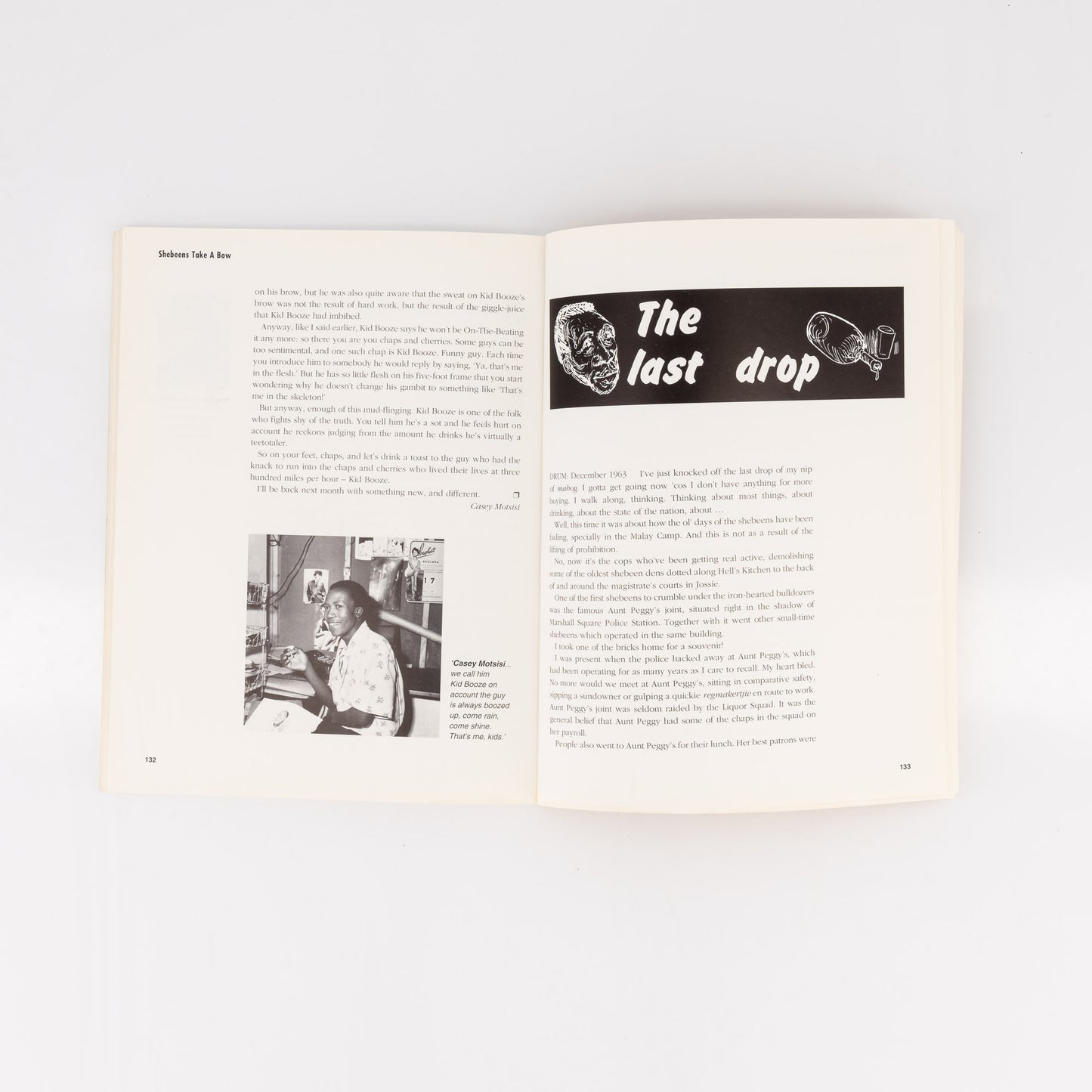 Open book with text and a black and white illustration on a white background