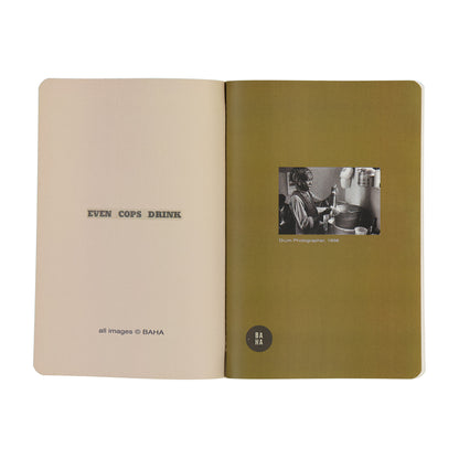 Open book with green cover and beige interior, featuring text and a black and white photo.