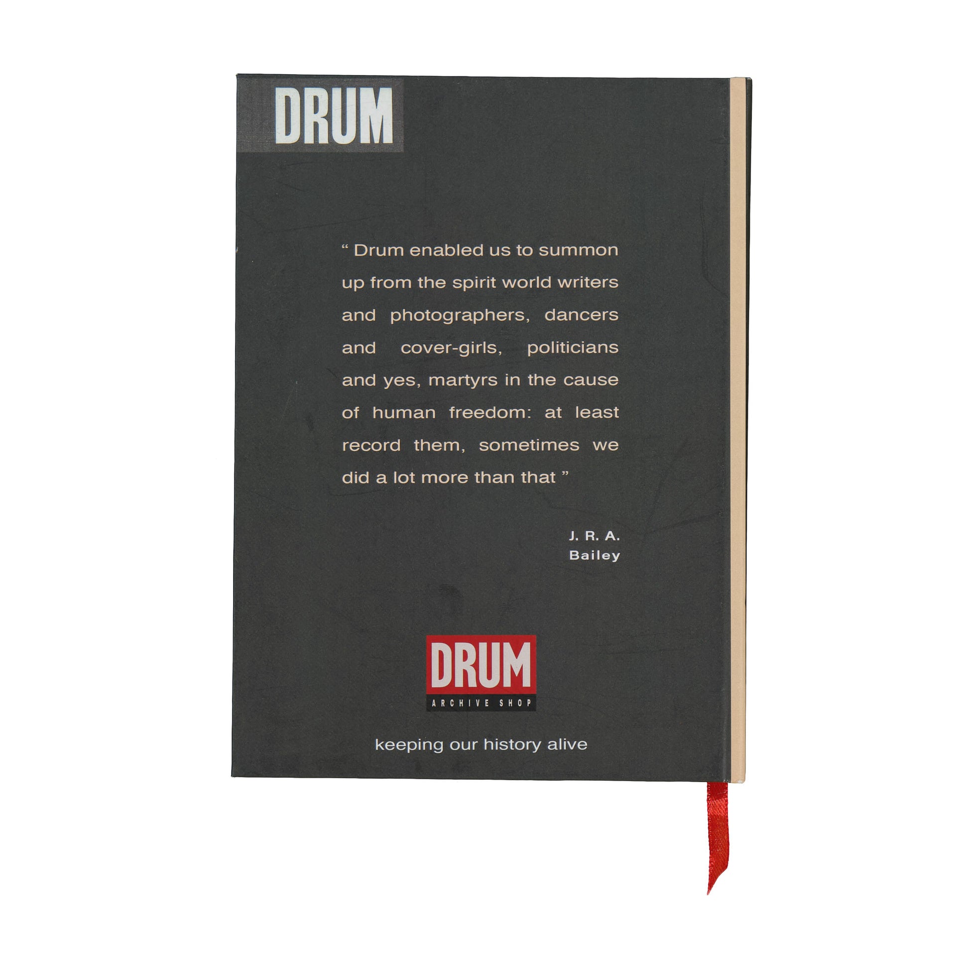 Black notebook with 'DRUM' branding and text on a white background