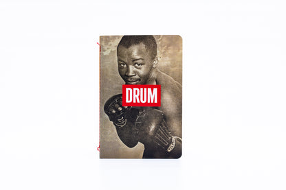 Notebook with a vintage-style cover featuring a boxer with the DRUM logo