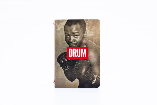 Notebook with a vintage-style cover featuring a boxer with the DRUM logo