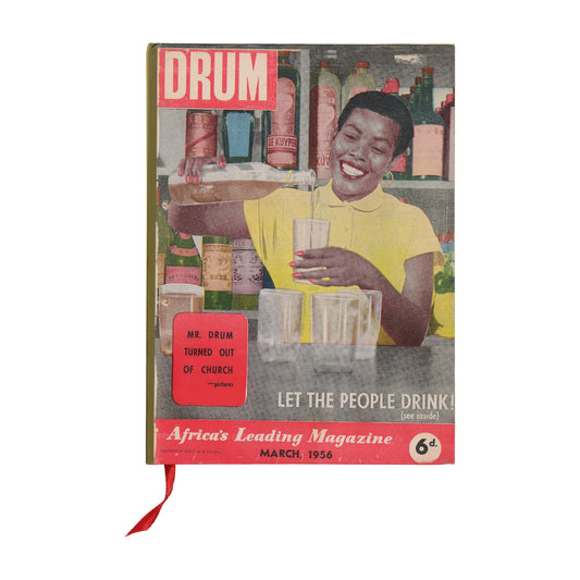 Notebook with a woman holding a glass of beer, featuring the title 'DRUM'.