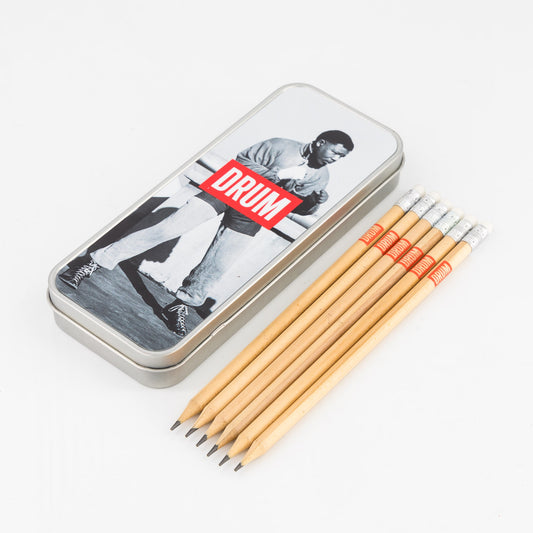Set of pencils with a tin featuring a Nelson Mandela and 'DRUM' text on a white background