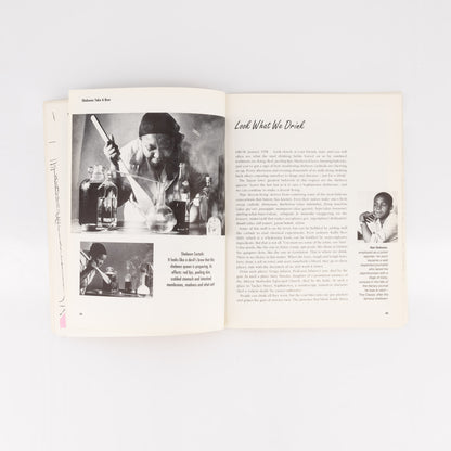 Open book with black and white photos and text on a white background