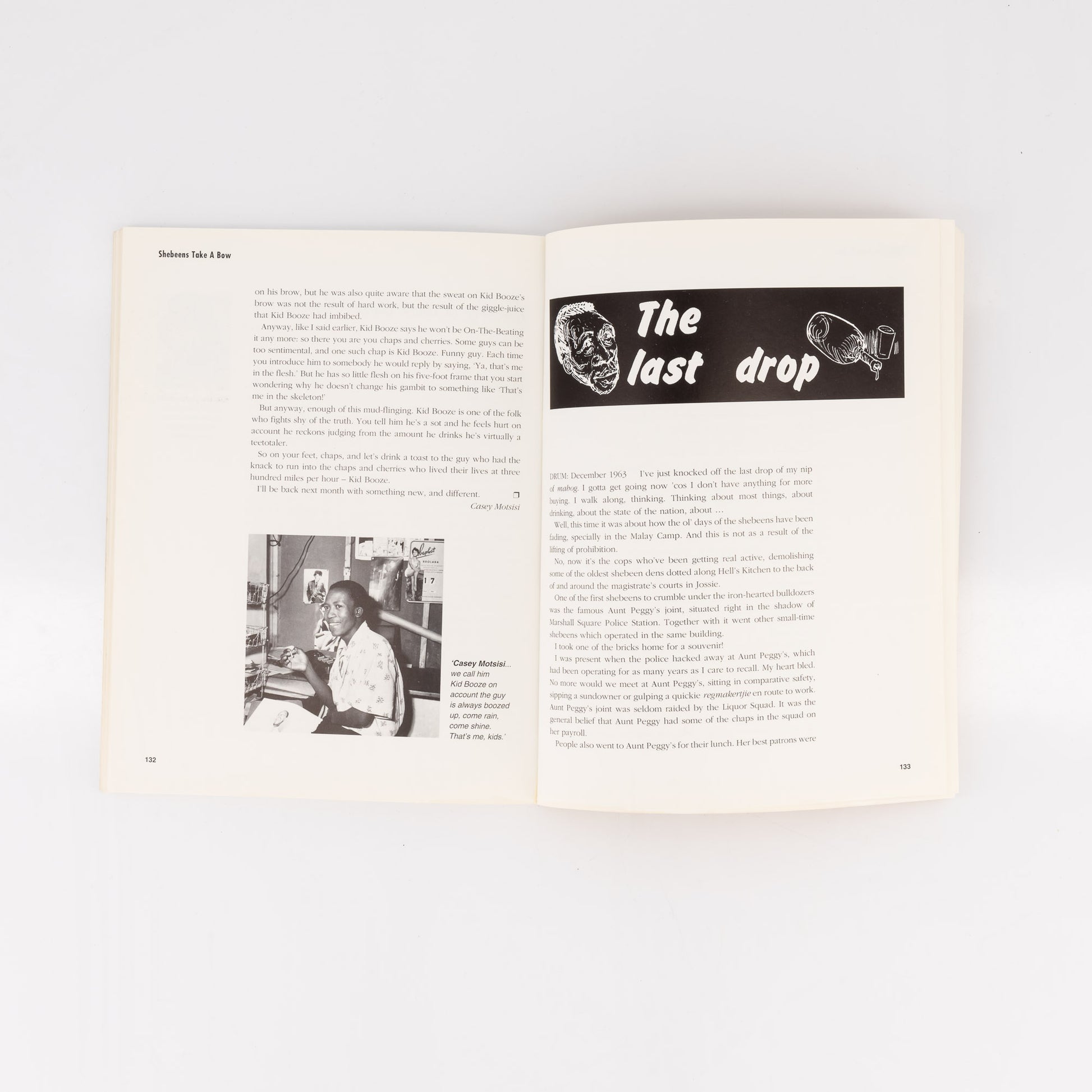 Open book with text and a black and white illustration on a white background