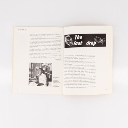 Open book with text and a black and white illustration on a white background