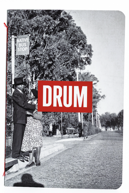 Book cover with a black and white photo of a man at a bus stop and a red 'DRUM' logo.